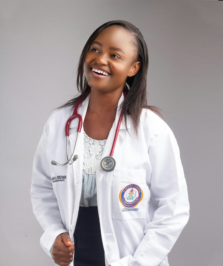 A smiling clinician in a white coat with a stethoscope